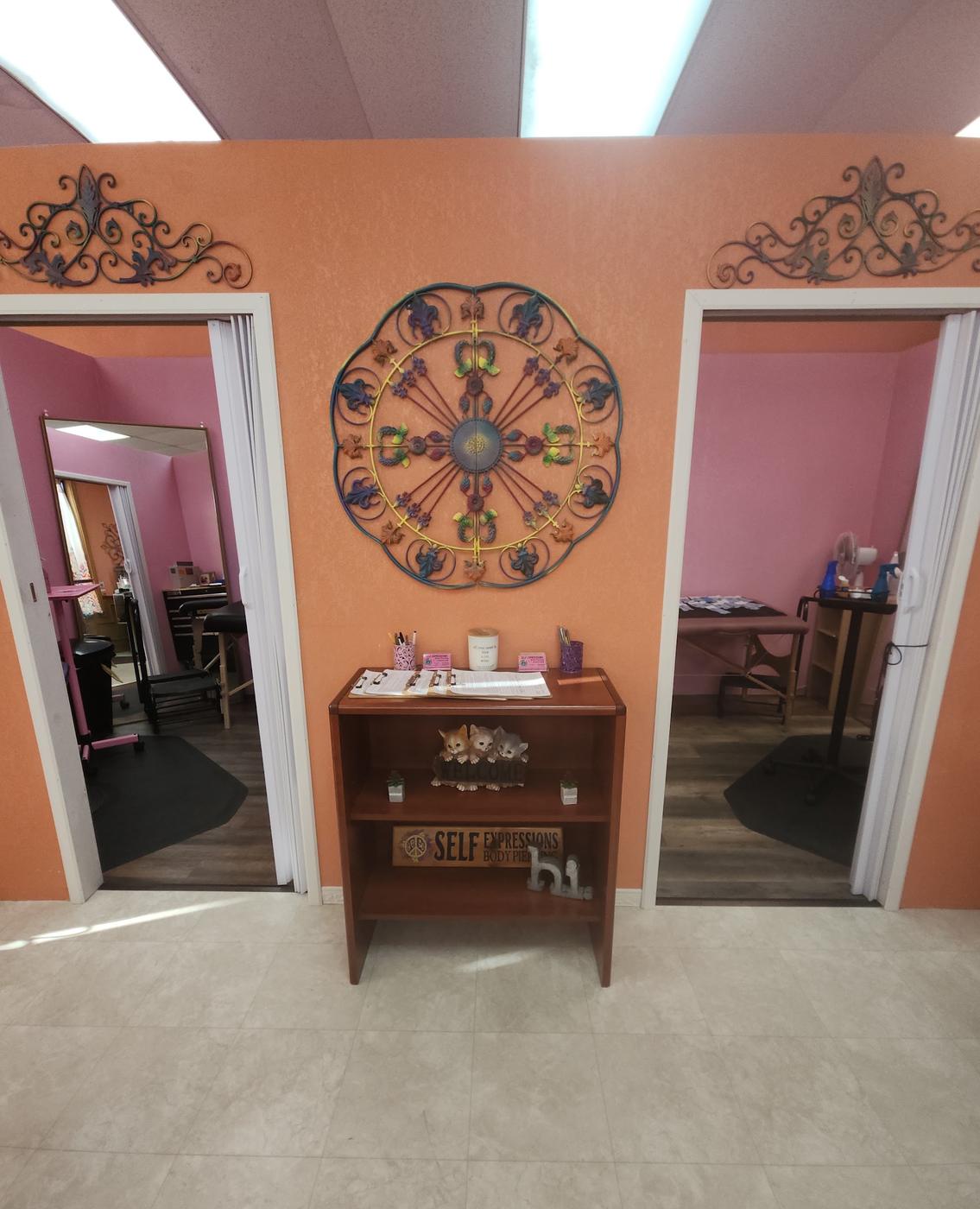 Two piercing rooms opening off a terracotta wall, each with a table made up and a mirror.